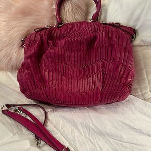 Large roomy Coach hot pink handbag. Some minor wear as shown at bottom of bag